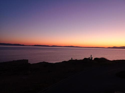 a sunset over a body of water at Magic Sea View apartment in Rafina
