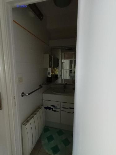 a small kitchen with a sink and a mirror at RESIDENCE LA NATURELLE Studio in Wimereux