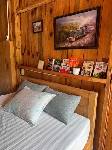 a bedroom with a bed and a painting on the wall at The Sound Of Silence Homestay Đà Lạt in Da Lat