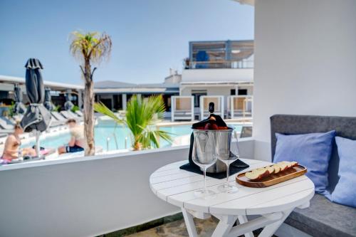 a table with a tea kettle and a tray of food at Aegean Paradiso Vacation Club - "Adults Only" in Azolimnos