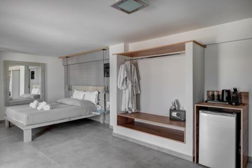 a bedroom with a bed and a mirror at Aegean Paradiso Vacation Club - "Adults Only" in Azolimnos
