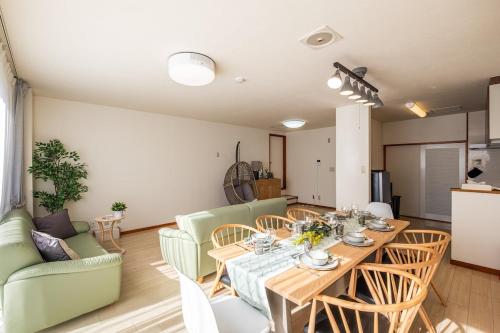 a living room with a table and chairs at Spacious Living and Garden 10 min walk from Shizuoka station in Shizuoka