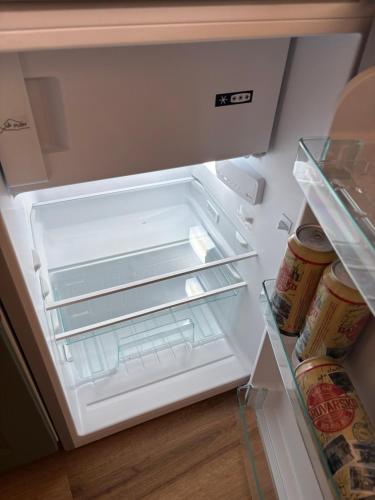 an empty refrigerator with its door open and food inside at Captain's house in Karlovac