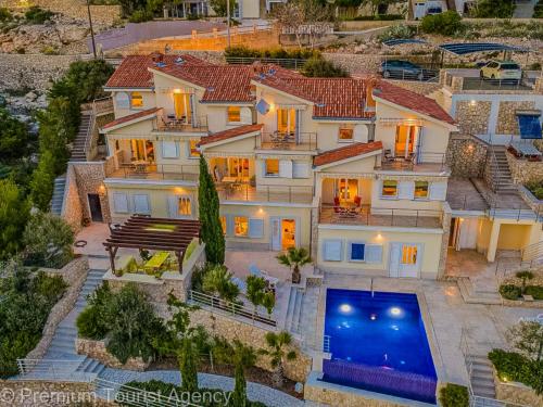 an aerial view of a house with a swimming pool at Villa Mia in Kustići