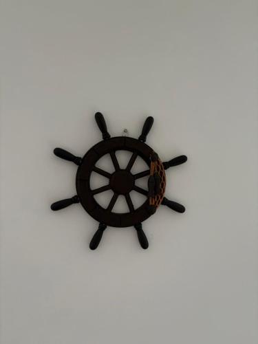 a wooden steering wheel on a white background at Captain's house in Karlovac