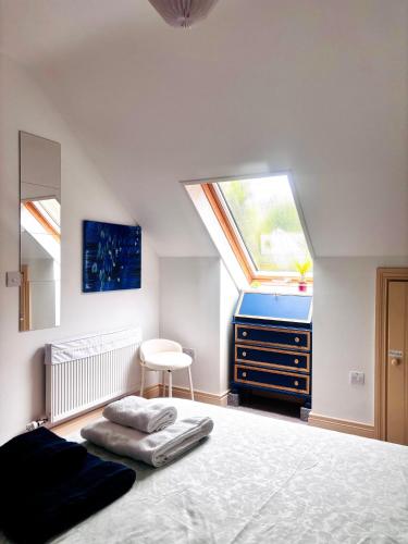 a bedroom with a bed and a dresser and a window at Streamside B and B with Parking in Drom dhá Liag