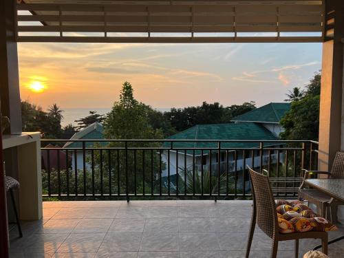 a balcony with a view of the ocean at sunset at Sunset Lover Hut in Salad Beach
