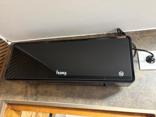 a television on top of a counter at Captain's house in Karlovac