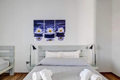 a bedroom with a bed with flowers on the wall at Aegean Paradiso Vacation Club - "Adults Only" in Azolimnos