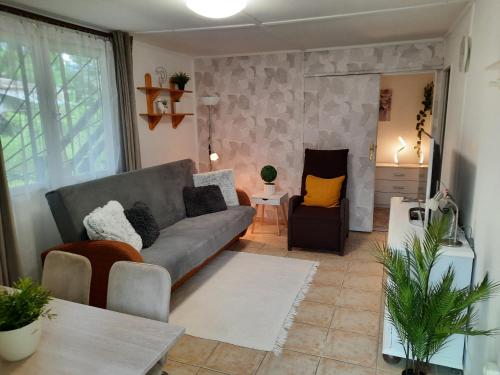a living room with a couch and a table at DunaLiget Vendégház in Szentendre