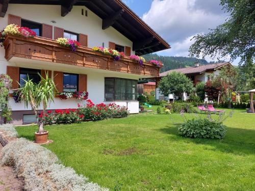 a house with flowers in the yard at Landhaus Tripolt in Radstadt