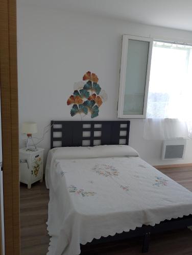 a bedroom with a bed and a window at Monolocale in campagna in Camporosso