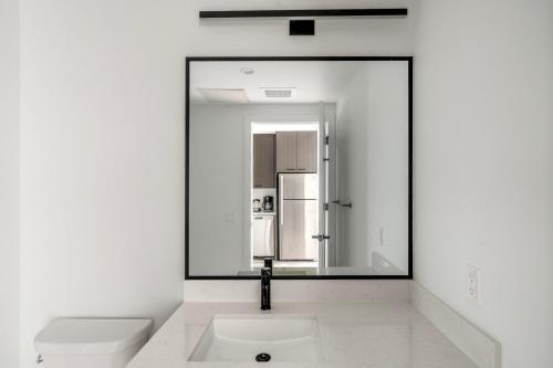 a bathroom with a sink and a mirror at Blueground Downtown Austin pool nr Capitol ATX-235 in Austin