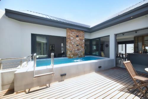 a pool on the deck of a house at Fynbos Hill Luxury Accommodation in Agulhas