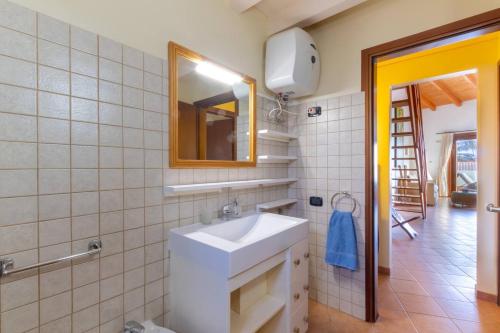 a bathroom with a white sink and a mirror at Porto Antigo 1 - Three Bedroom, Pool & Wifi in Santa Maria