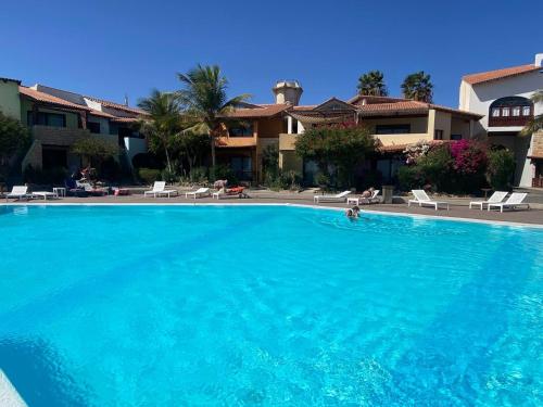 a large blue swimming pool in a resort at Porto Antigo 1 - Three Bedroom, Pool & Wifi in Santa Maria