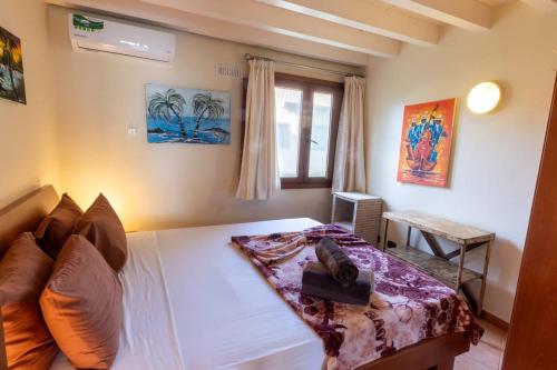 a bedroom with a bed and a window at Porto Antigo 1 - Three Bedroom, Pool & Wifi in Santa Maria