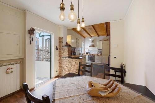 a kitchen and dining room with a wooden table at Romantica e Accogliente Mansardina in Savona