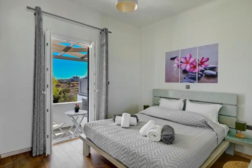 a bedroom with a bed with towels on it at Aegean Paradiso Vacation Club - "Adults Only" in Azolimnos