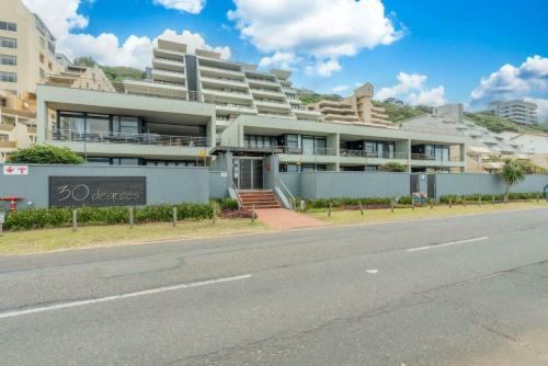 a large building on the side of a street at Elegant Family Retreat with Ocean Views in Umdloti