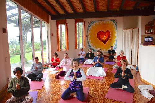 a group of people sitting in a room doing yoga at ALL ONE Catamaran in Ponta Delgada