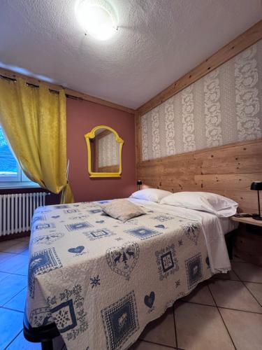 a bedroom with a bed with a blanket on it at Rêve en ville in Aosta