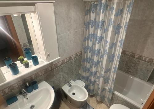 a bathroom with a sink and a toilet and a shower at Bahia Park, Steps from beach! in Oropesa del Mar
