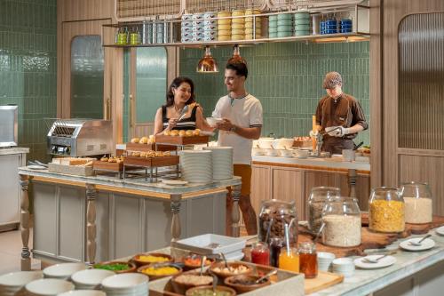 a group of people in a kitchen preparing food at Hyatt Place Bangkok Sukhumvit 1 in Bangkok