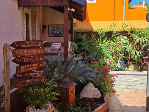 a store with a bunch of signs in a garden at Bed & Breakfast Villa Adriana in Premantura
