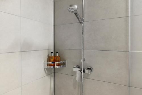 a shower with a shower head in a bathroom at Ariv Design Hotel Zug in Zug