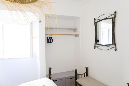a room with a mirror and a bench at Casinha da Raposeira in Raposeira