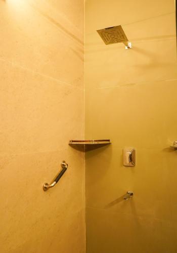 a bathroom with a shower with a towel rack at Neelesh Inn- A Luxury Lake View Hotel- 20 kms from Nainital in Bhīm Tāl