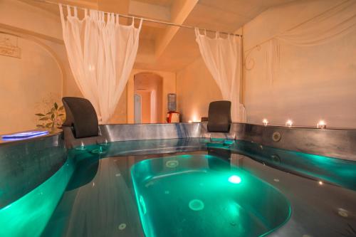 a swimming pool with a green tub in a room at Hotel Spiaggia d'Oro - Charme & Boutique - Garda Lake Collection in Salò