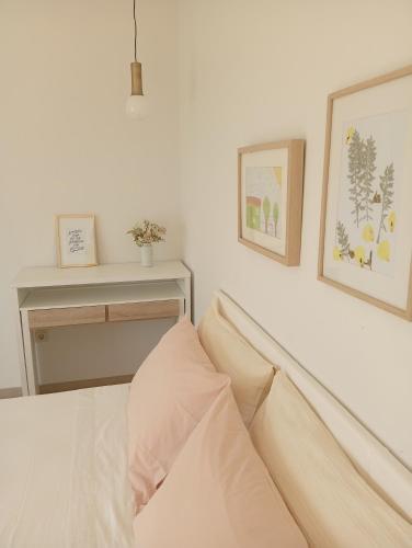a bedroom with a bed with two pictures on the wall at Casa da Marquinhas in Ventozelo