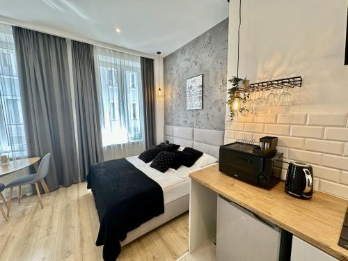 a bedroom with a bed and a desk in it at BOOGIE Home Kamienica Łódzka in Łódź
