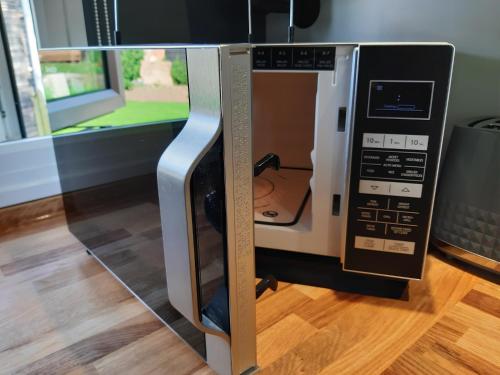 a microwave oven with its door open in a kitchen at All Manor Of Events - Glamping Pods in Henley