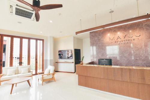 a lobby with a waiting area with a ceiling fan at Mayuu Ayutthaya Hotel in Ban Ko Rian
