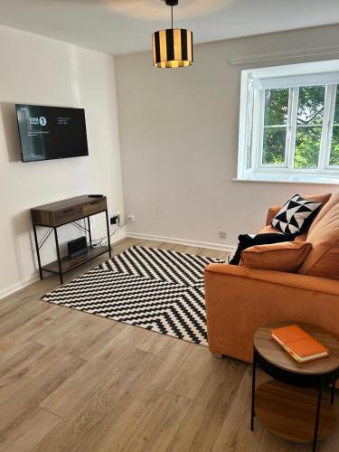 a living room with a couch and a table at Niamh's Place in Northallerton