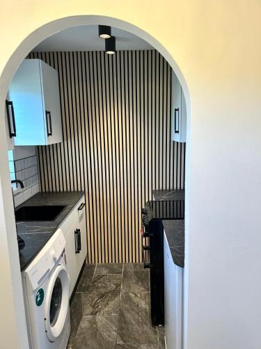 a bathroom with a sink and a washer at Niamh's Place in Northallerton