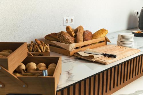 a counter with boxes of bread and baskets of pastries at Anna Island in Pefkohori