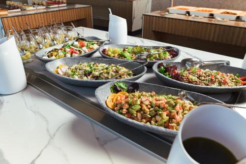 a buffet with many trays of food on a table at Anna Island in Pefkohori
