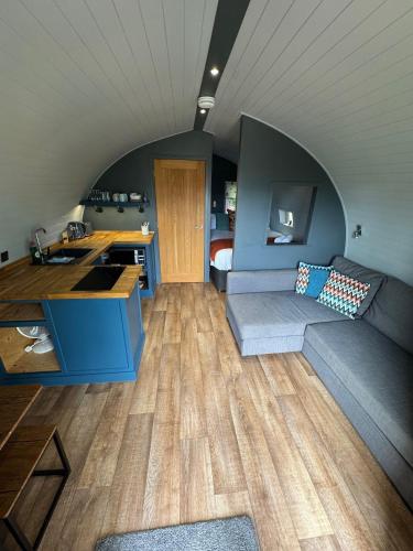 a kitchen and living room with a couch and a table at All Manor Of Events - Glamping Pods in Henley