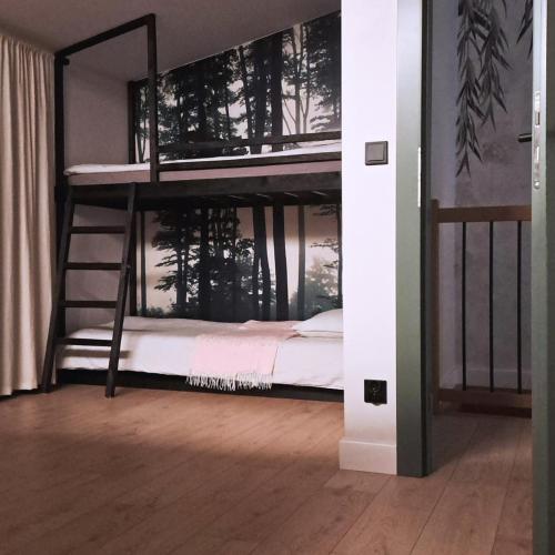 a bedroom with two bunk beds with a window at Zakontek Lubkowa in Lubkowo