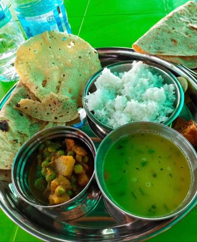 a plate of food with a plate of food with soup and bread at Rks kashid beach villa in Kashid