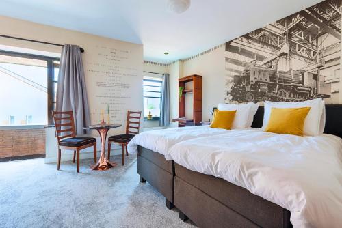 a bedroom with a large bed and a table and chairs at City Center Stay Fast Wi-fi, Designer Bathroom in Tilburg