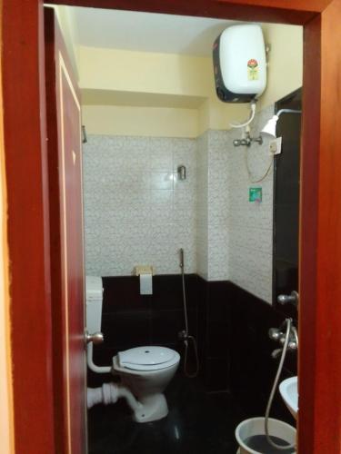 a small bathroom with a toilet and a sink at SHIVANGAN HOTEL and BANQUET in kolkata