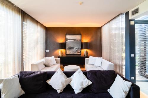 a living room with a couch and a table at Designer Villa in Comporta in Troia