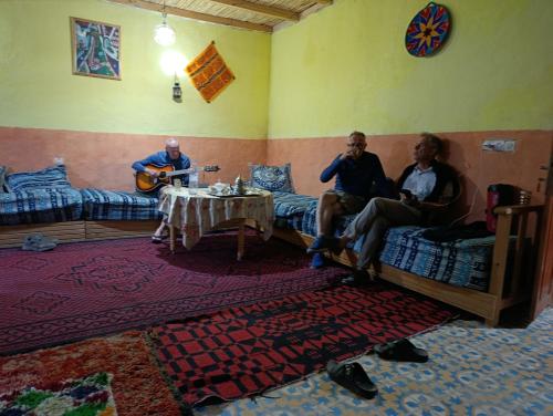a group of men sitting in a room playing music at KASBAH Atlas-Aberdouz in Aït Hattab