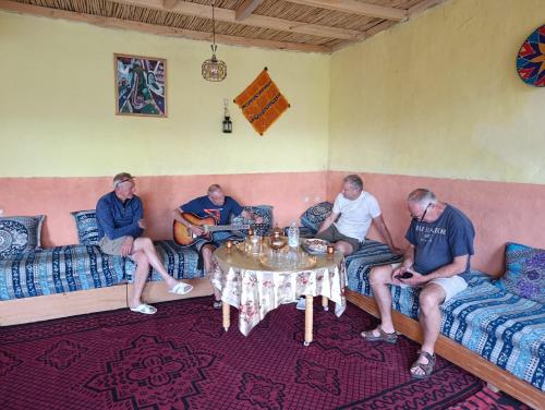a group of people sitting around a table in a room at KASBAH Atlas-Aberdouz in Aït Hattab