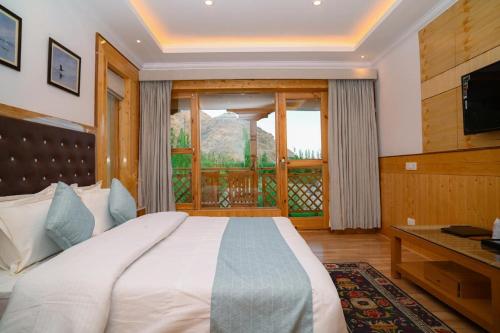 a bedroom with a large bed and a window at The Countryside Villa Ladakh in Shey